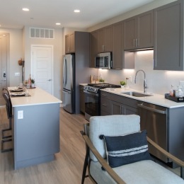 a kitchen with an island and a chair