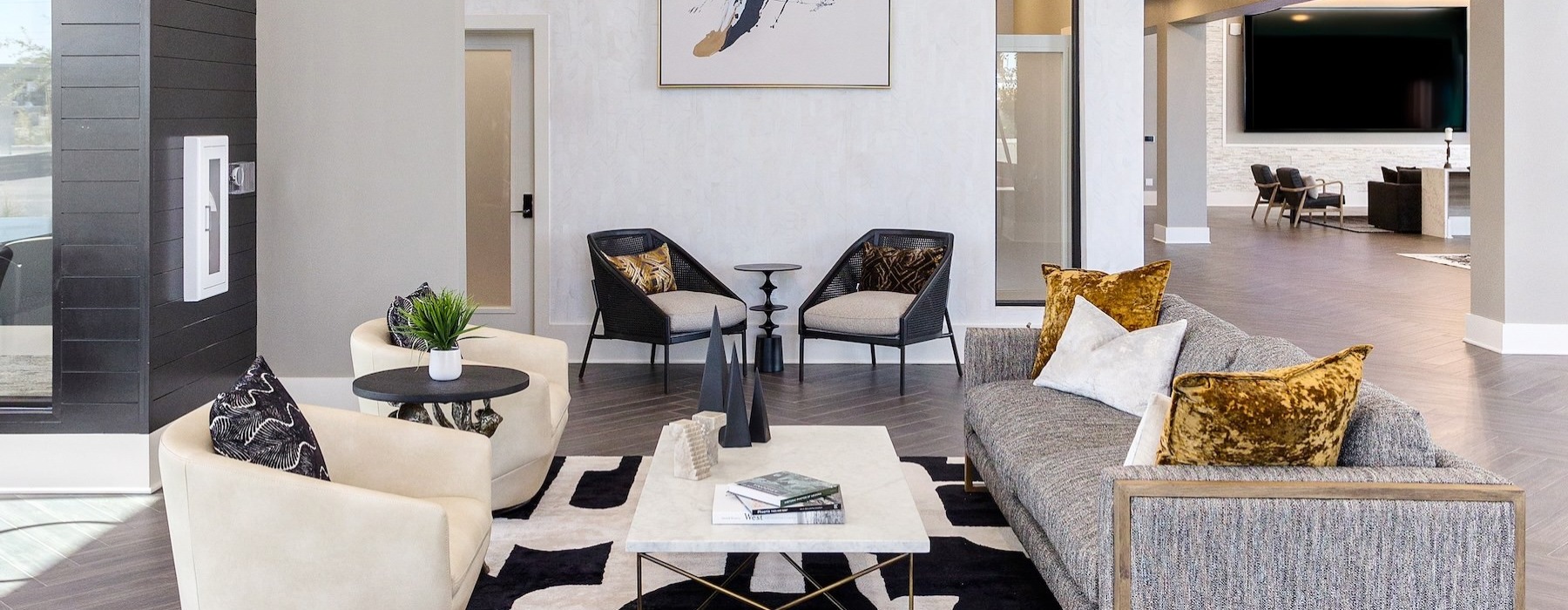 a clubroom with a couch, table and chairs