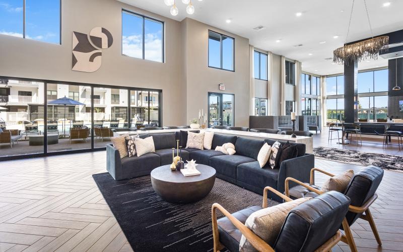 a clubroom with a couch, chairs and a coffee table