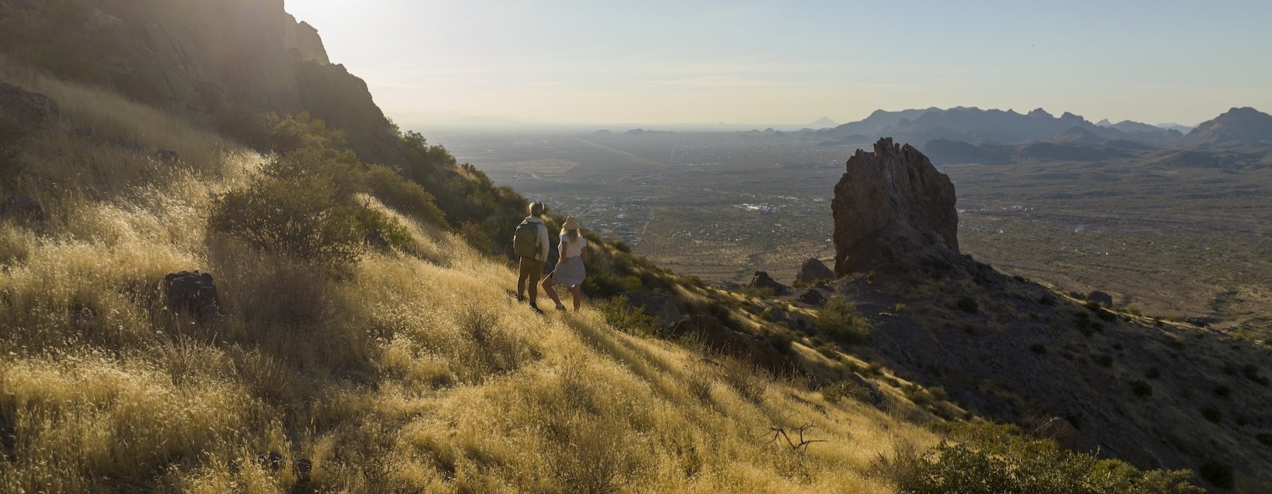 a group of people walking on a hill