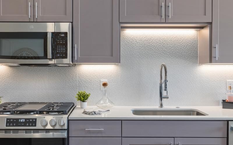 a kitchen with grey cabinets